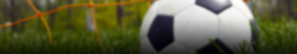 blurred photo of soccer ball near a soccer goal