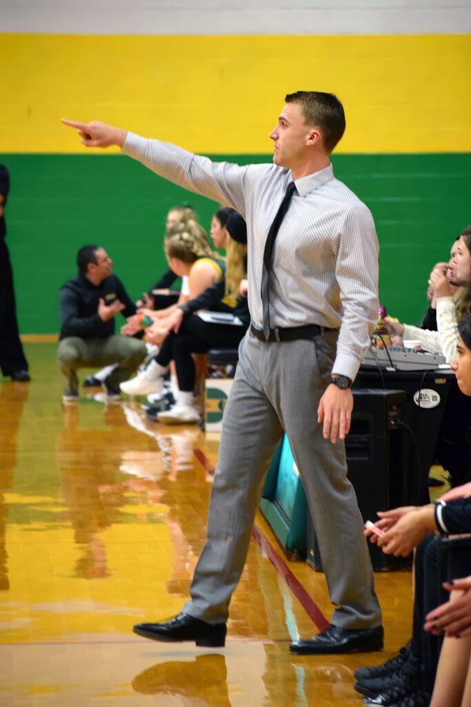 Coach Brown on the sidelines during a game, directing his players