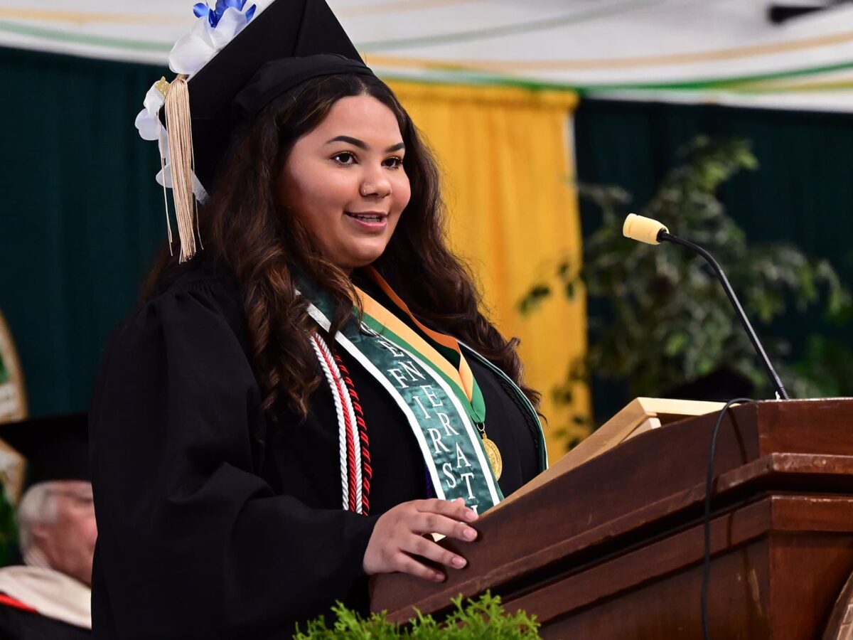 a 2024 female UMFK graduate addresses her class during the 2024 commencement ceremony