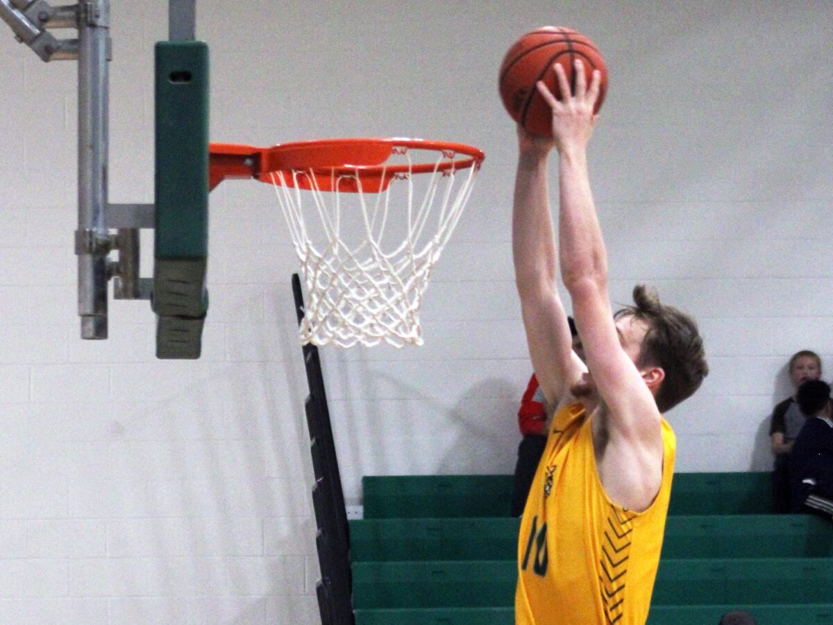 a UMFK men's basketball player goes up to the basket for a dunk